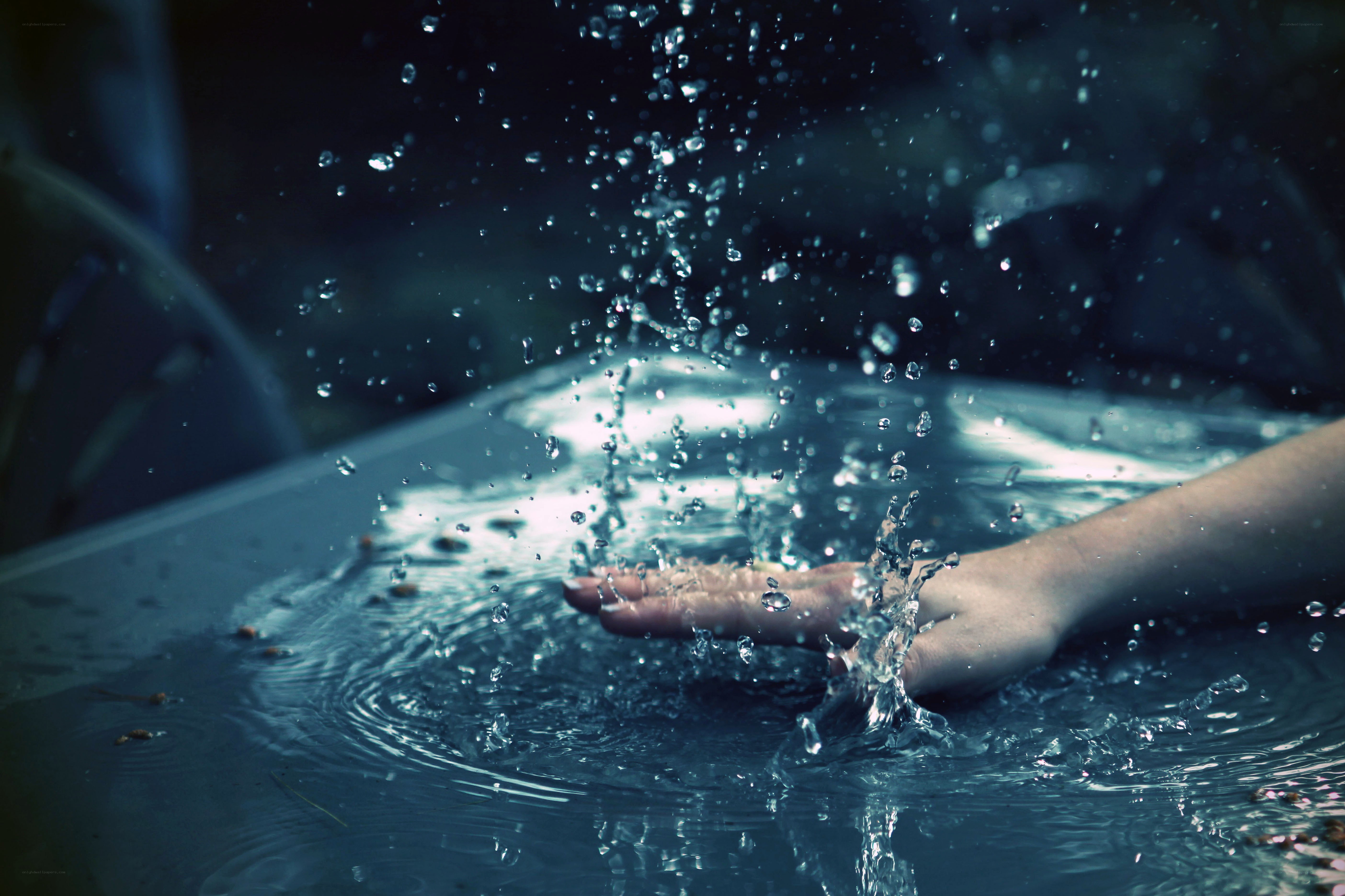 hand splashing in water