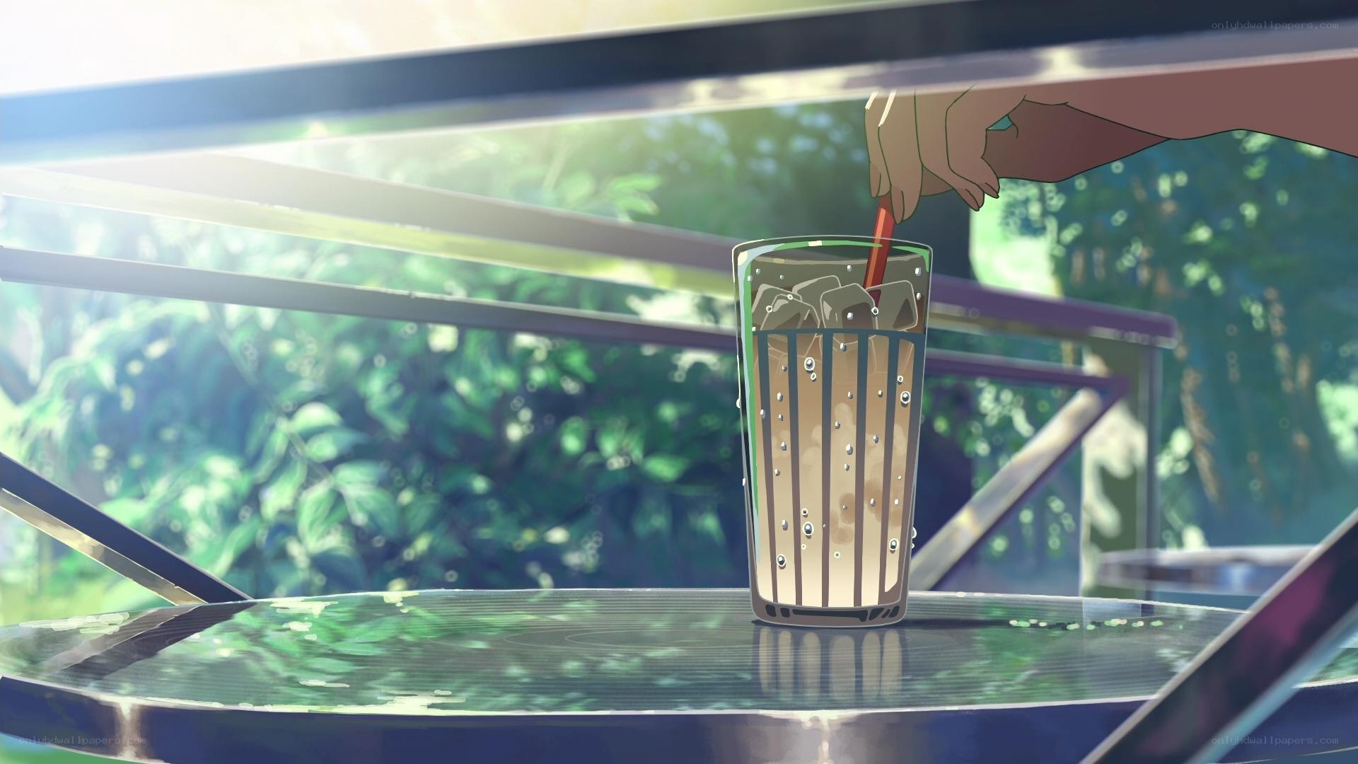 Hand stirring drink in glass