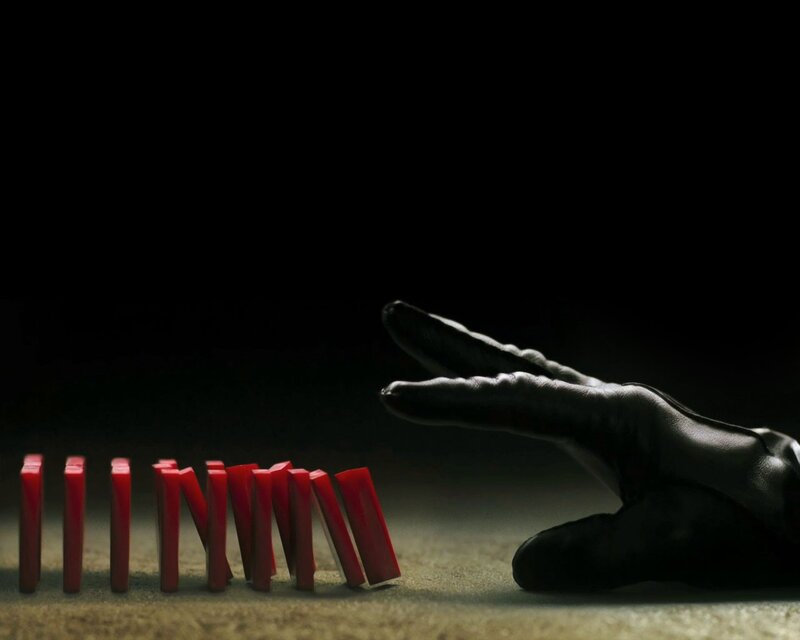 Hand stopping dominoes
