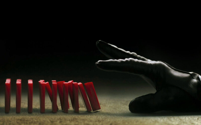 hand stopping dominoes