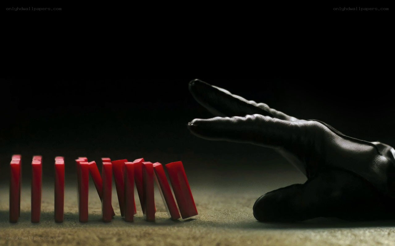 hand stopping dominoes