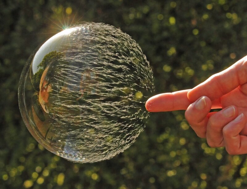 Hand touching a bubble