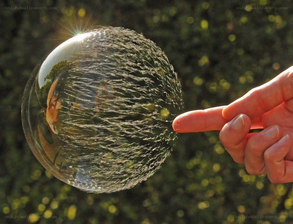 Hand touching a bubble