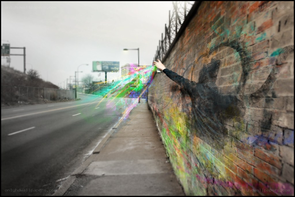 hand touching colorful light on wall