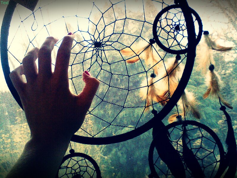 hand touching dreamcatcher