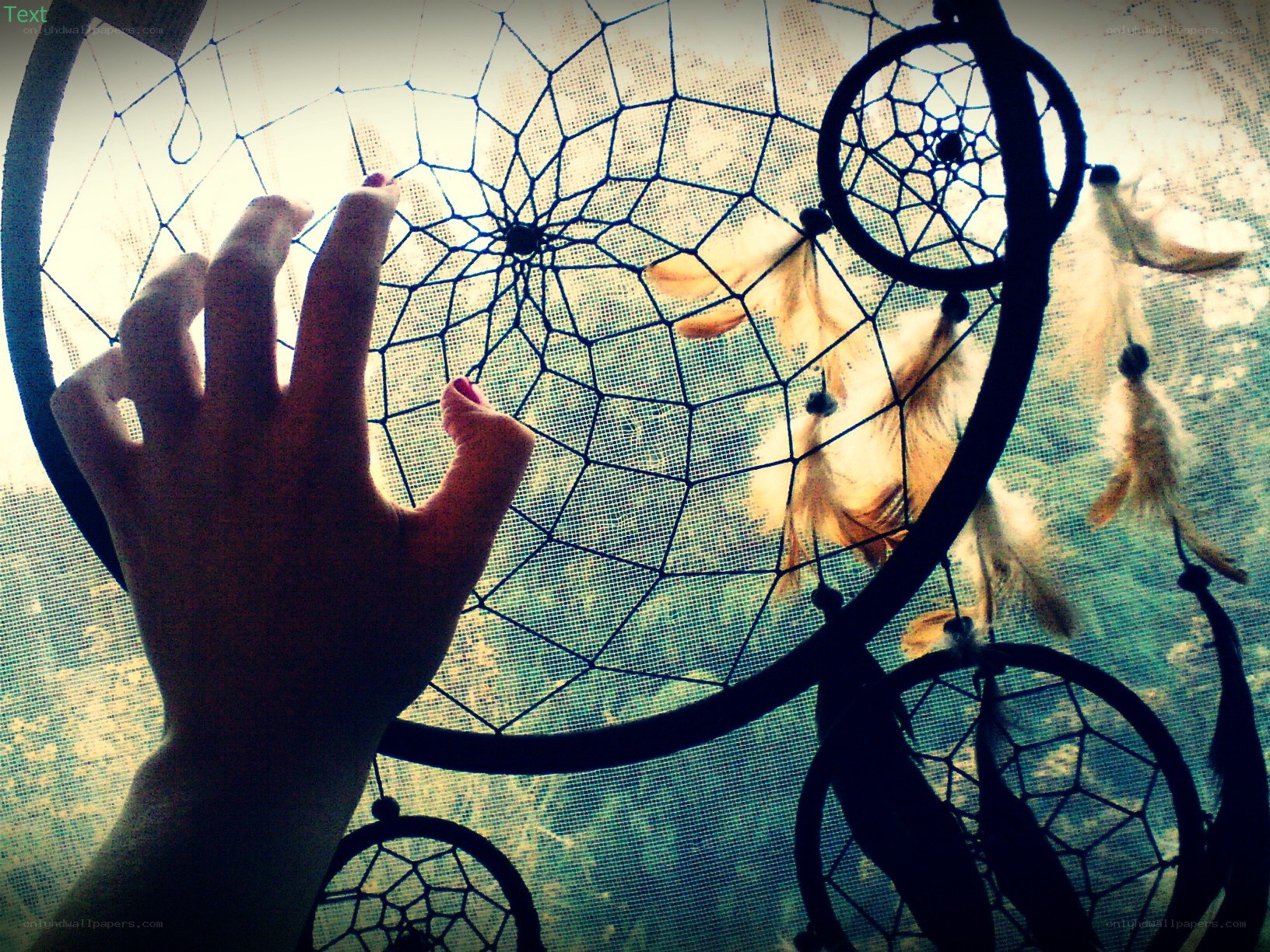 hand touching dreamcatcher