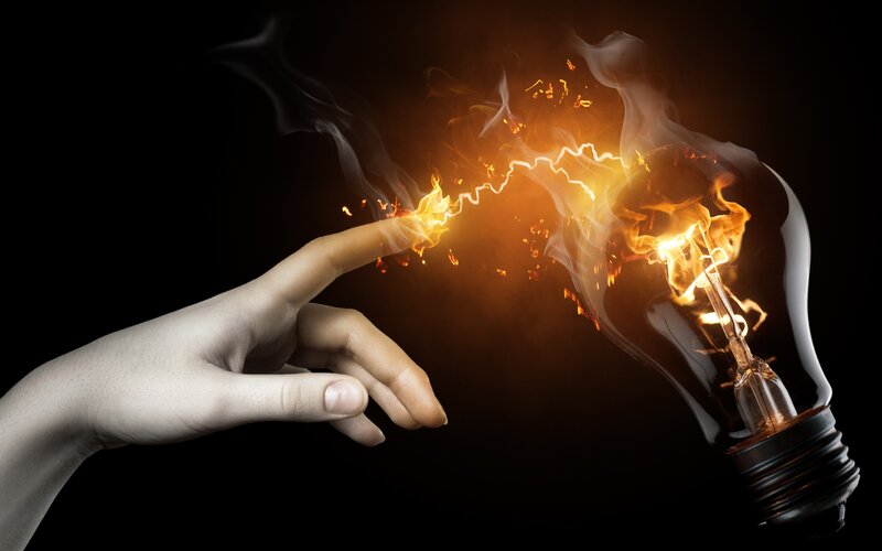 Hand Touching Light Bulb — Fire