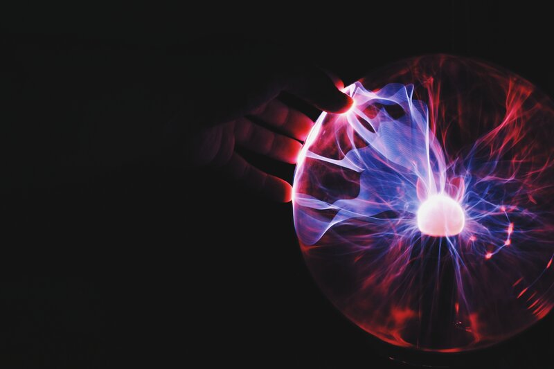 hand touching plasma ball