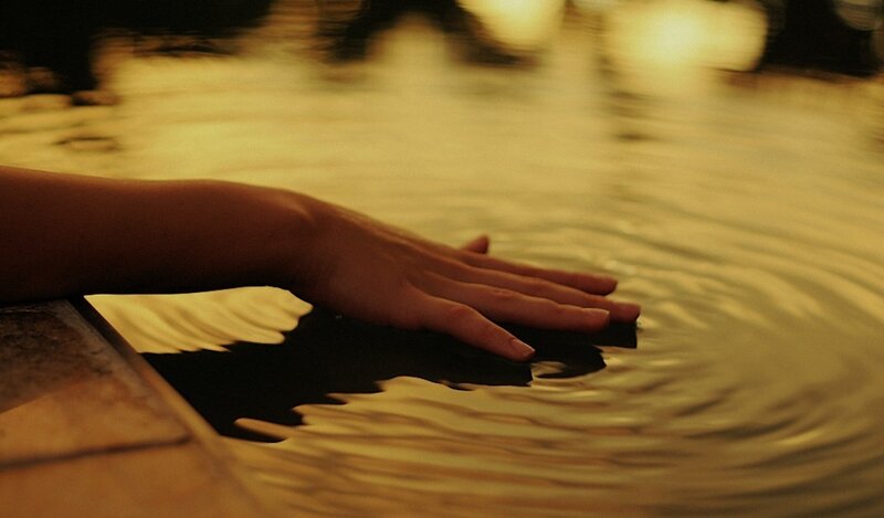 Hand Touching Water