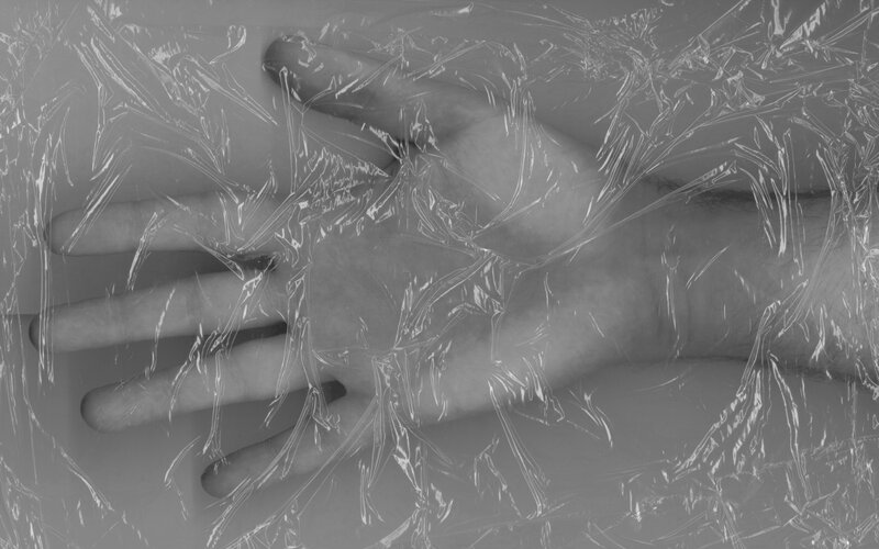 hand under plastic wrap