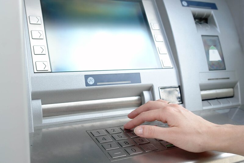 hand using ATM machine