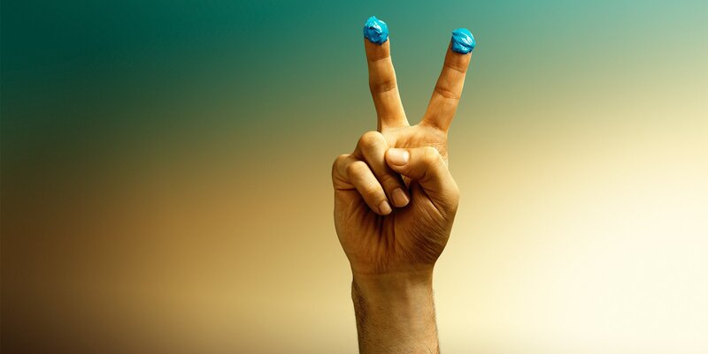hand with blue ink on fingers