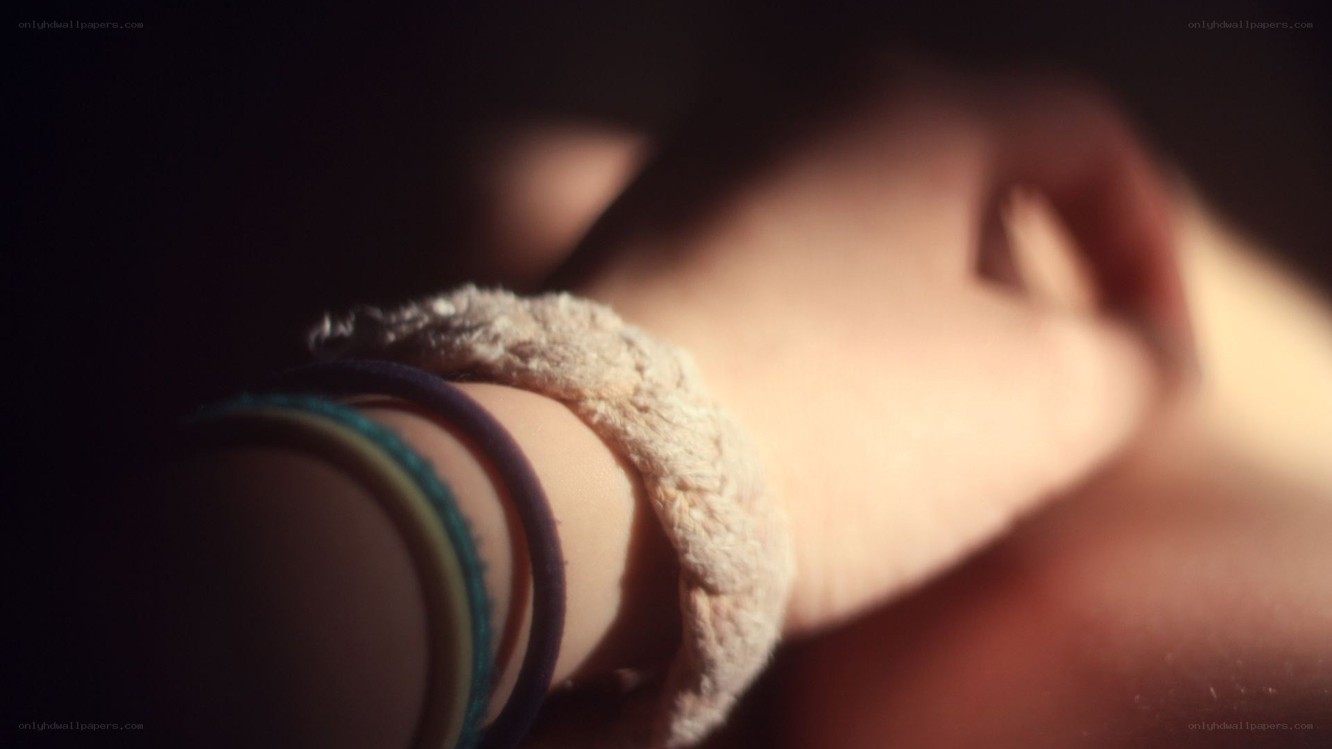 hand with bracelets in dim light