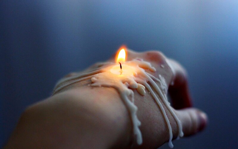 Hand with Burning Candle