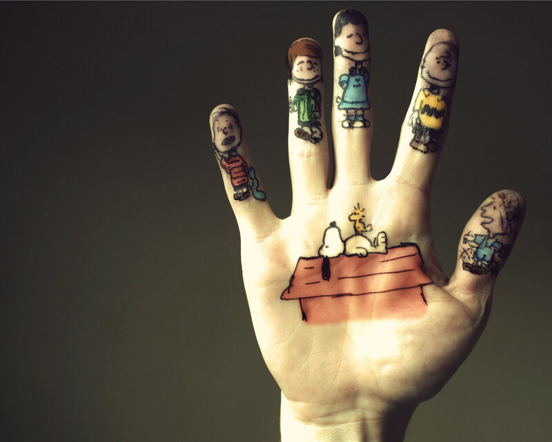 Hand with Cartoon Drawings