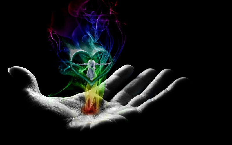 hand with colorful energy heart