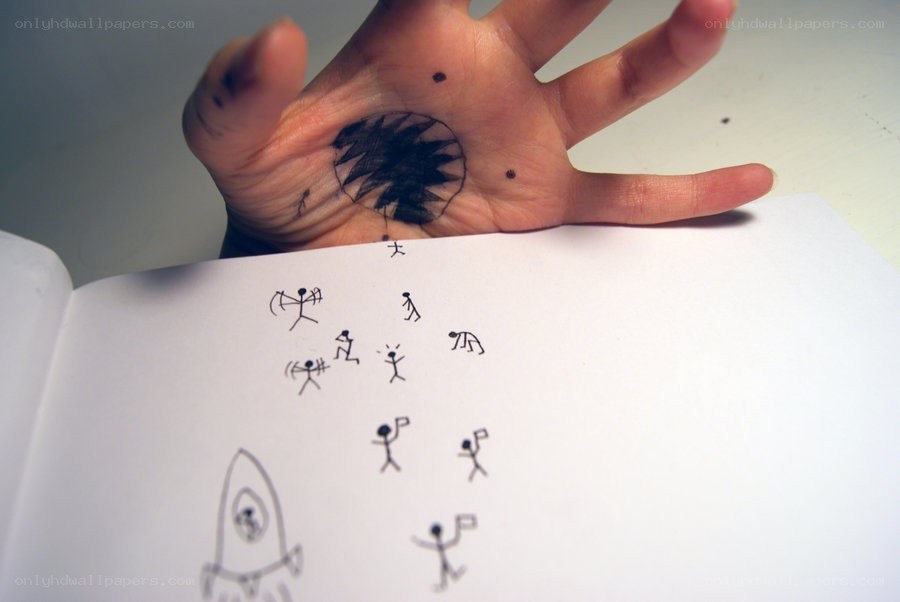 Hand with drawing and sketchbook