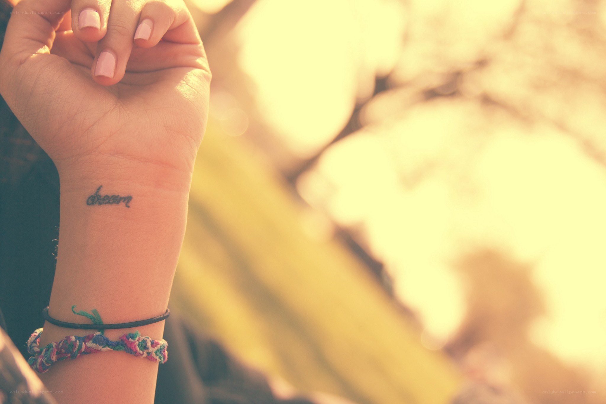 hand with dream tattoo