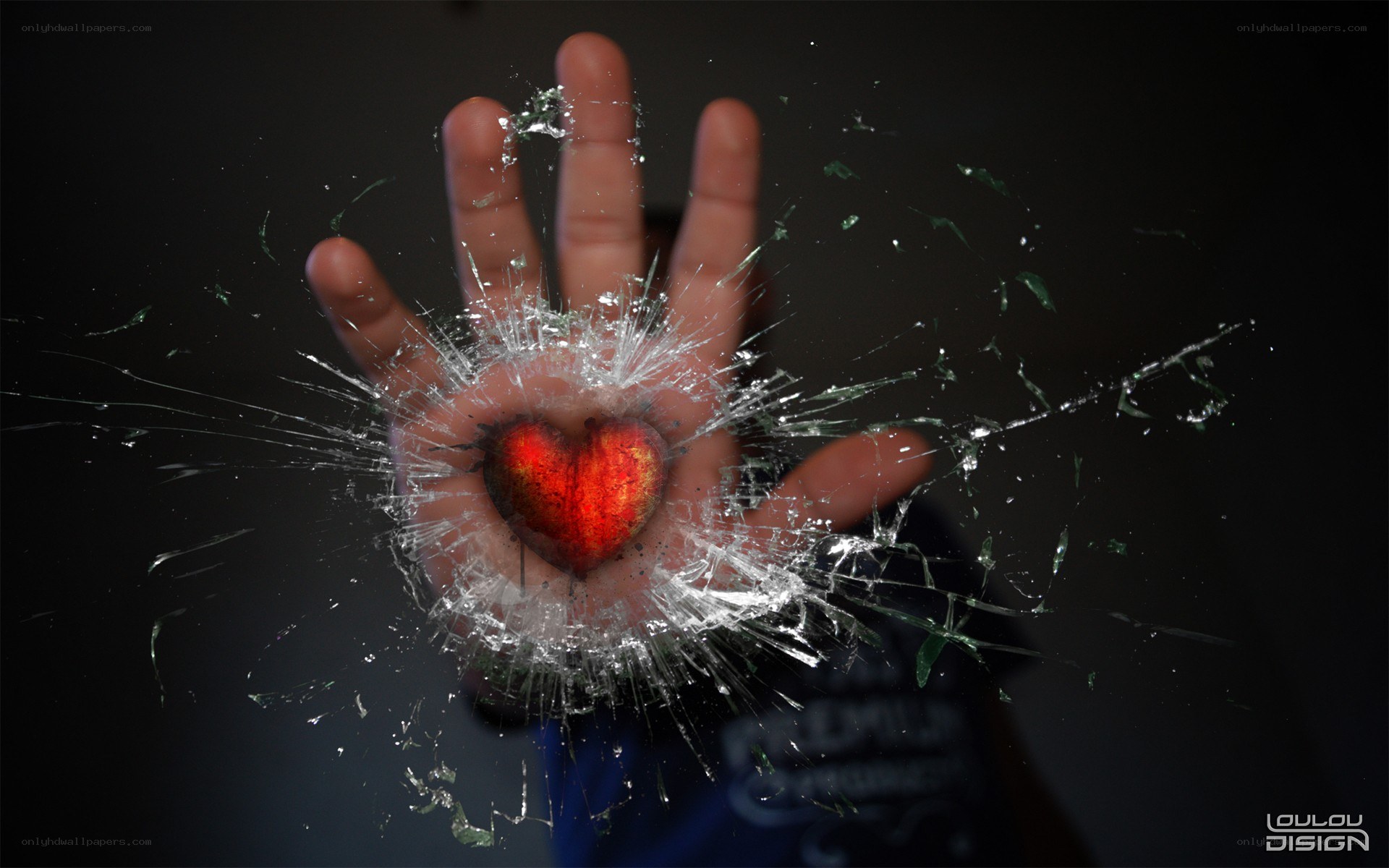 hand with heart behind broken glass