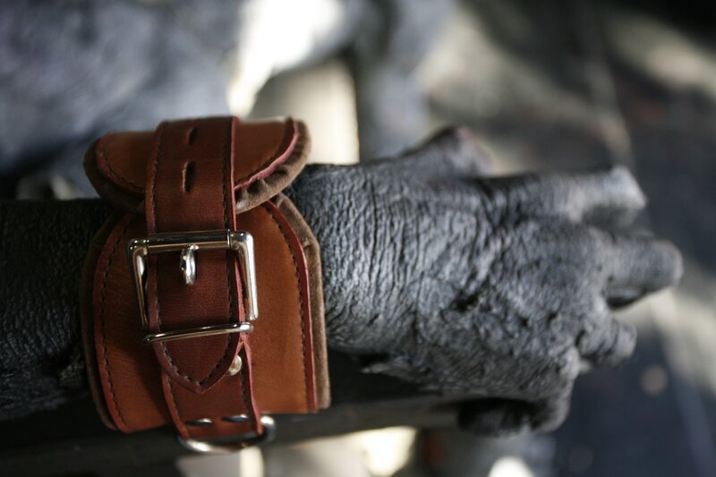 hand with leather restraint