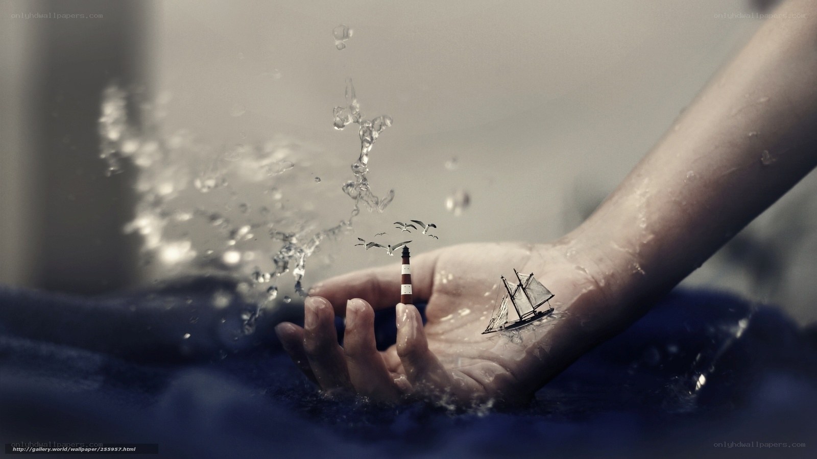 Hand with miniature ship and lighthouse