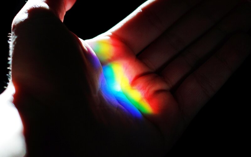 hand with rainbow light