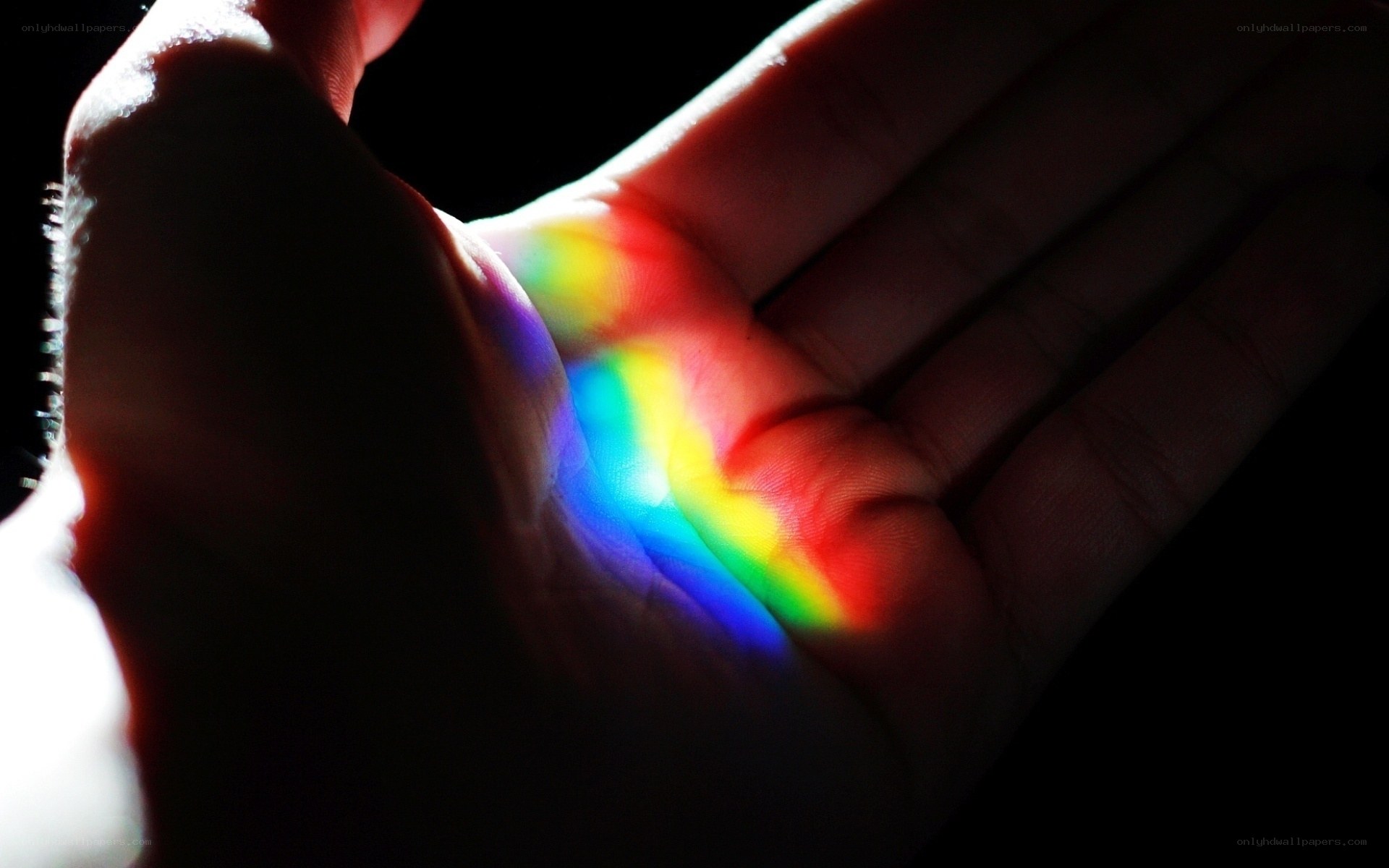hand with rainbow light