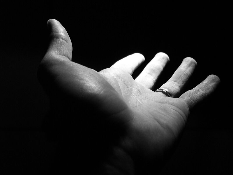 hand with ring in spotlight