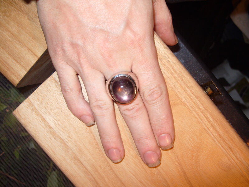 hand with ring on wood