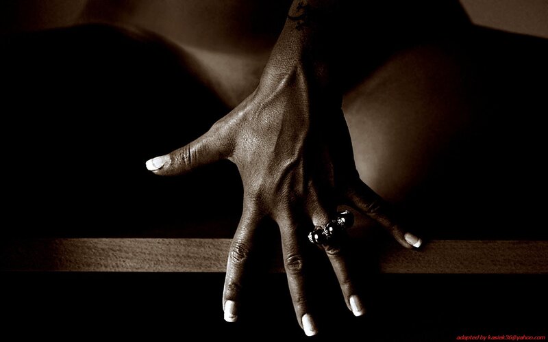 hand with ring on wooden surface