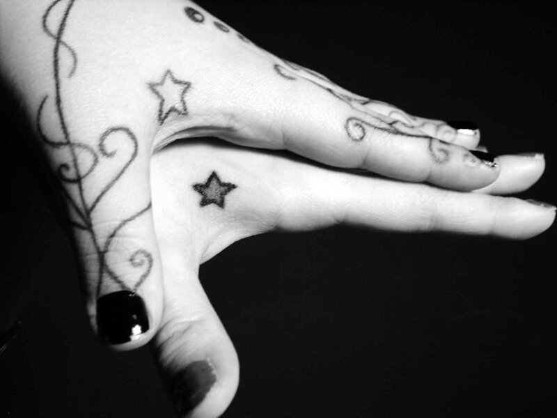 hand with star tattoos