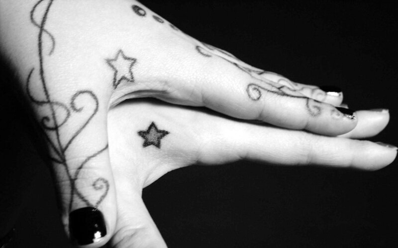 hand with star tattoos