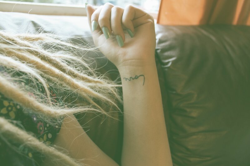 hand with tattoo and dreadlocks