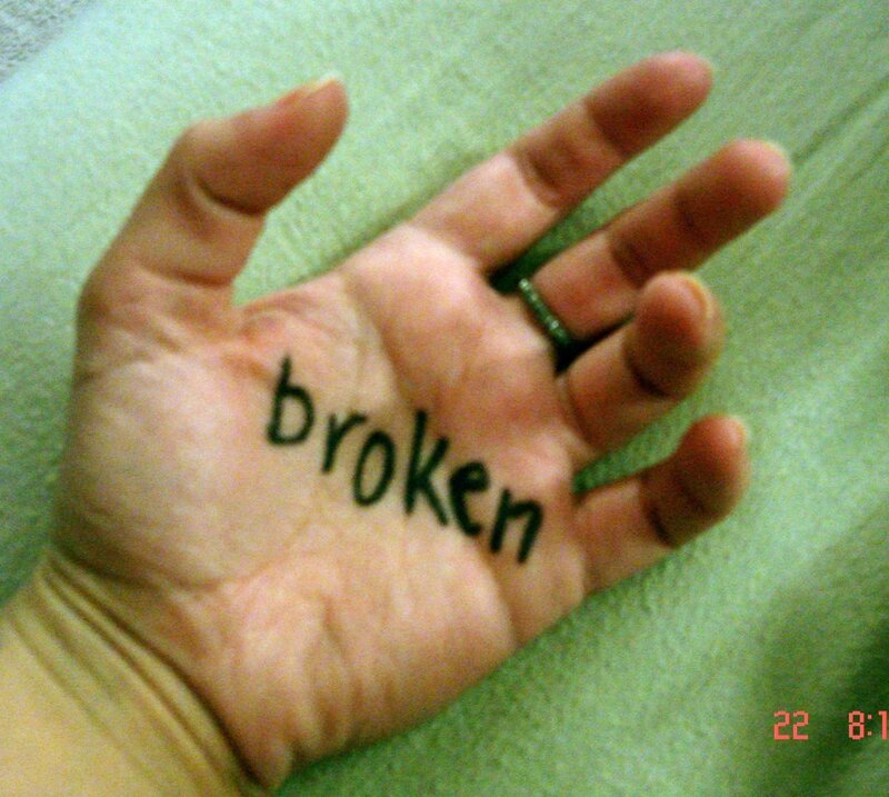 hand with word 'broken' written on it