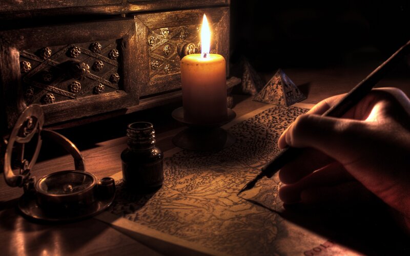 hand writing on a map by candlelight