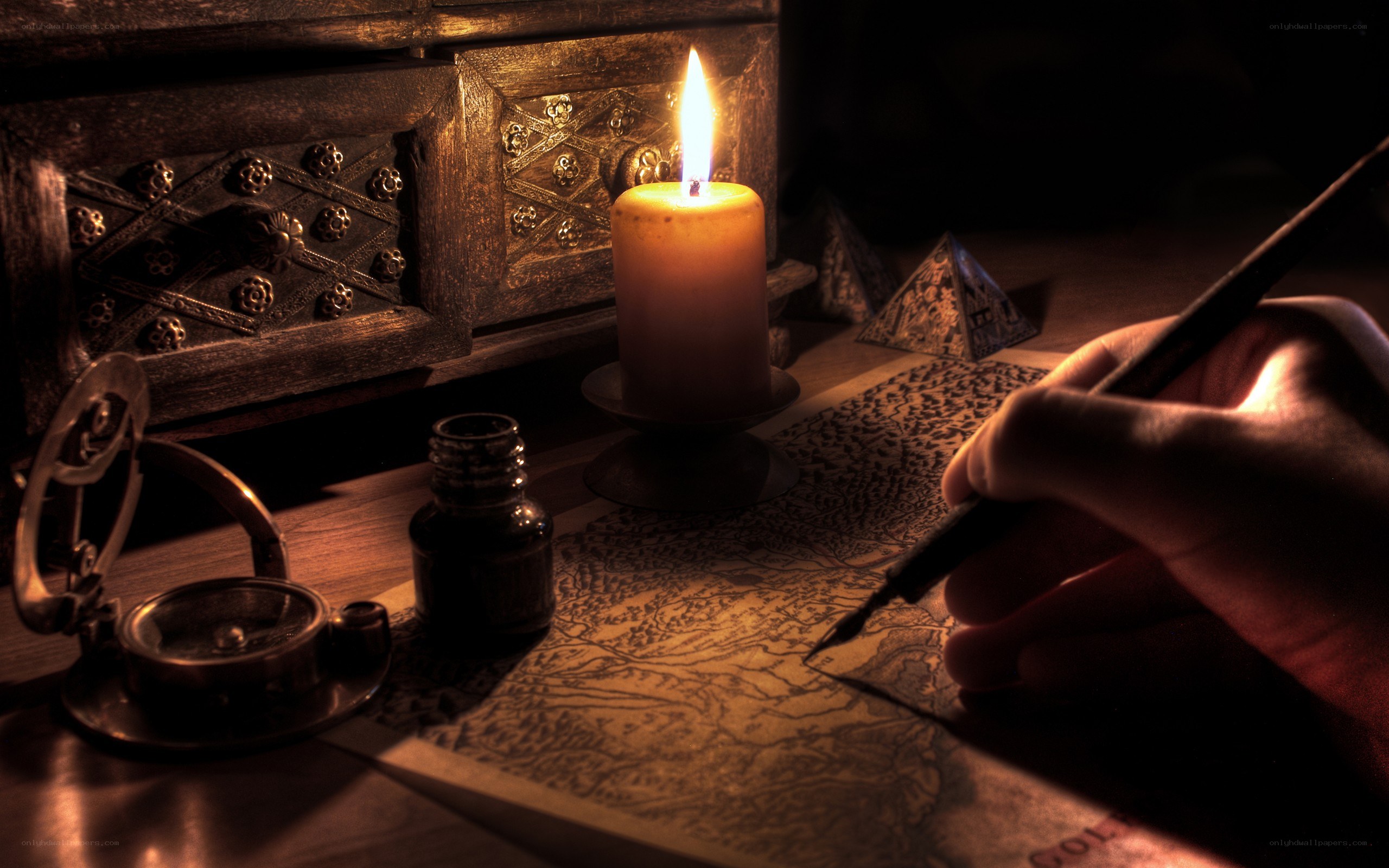 hand writing on a map by candlelight