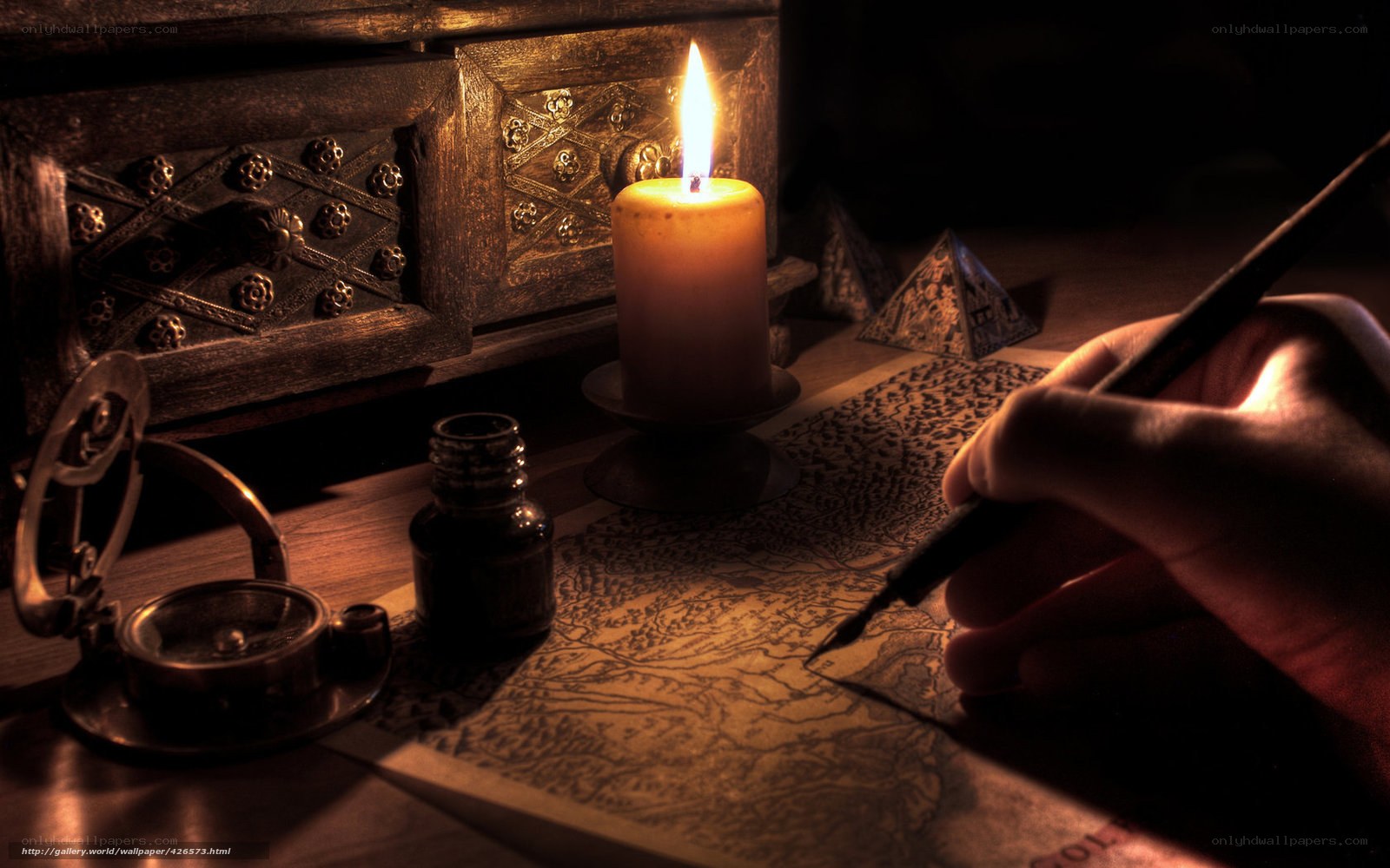 Hand writing on a map by candlelight