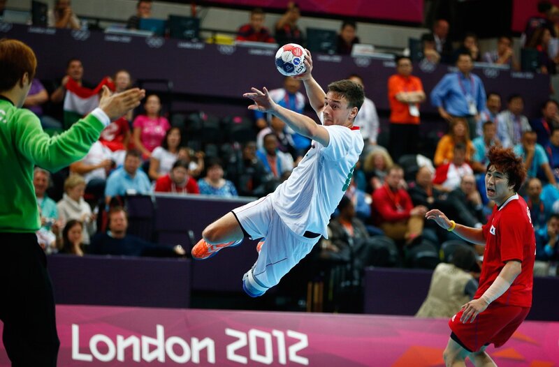 Handball player in mid-air throw