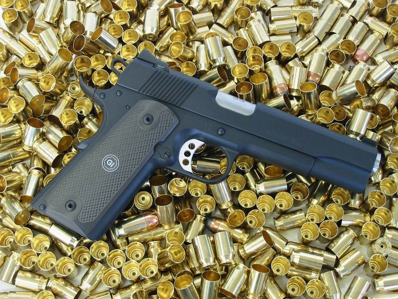 Handgun surrounded by bullet casings