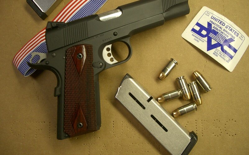 handgun with ammunition and membership card