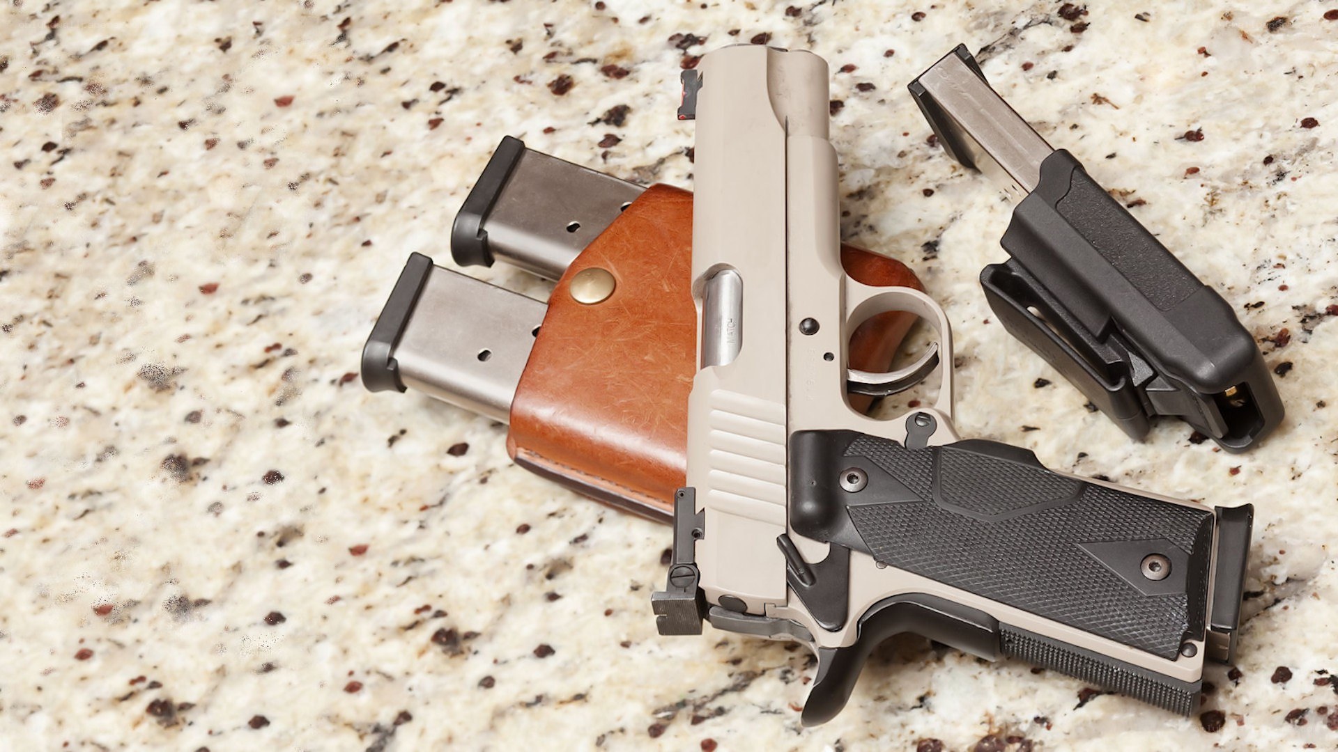 handgun with magazines and holster