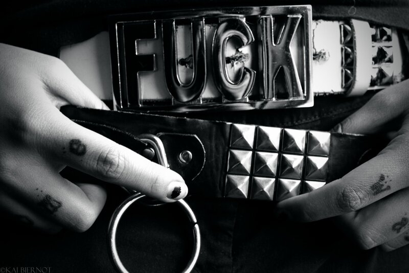 Hands adjusting a studded belt