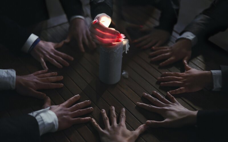 Hands Around Candle