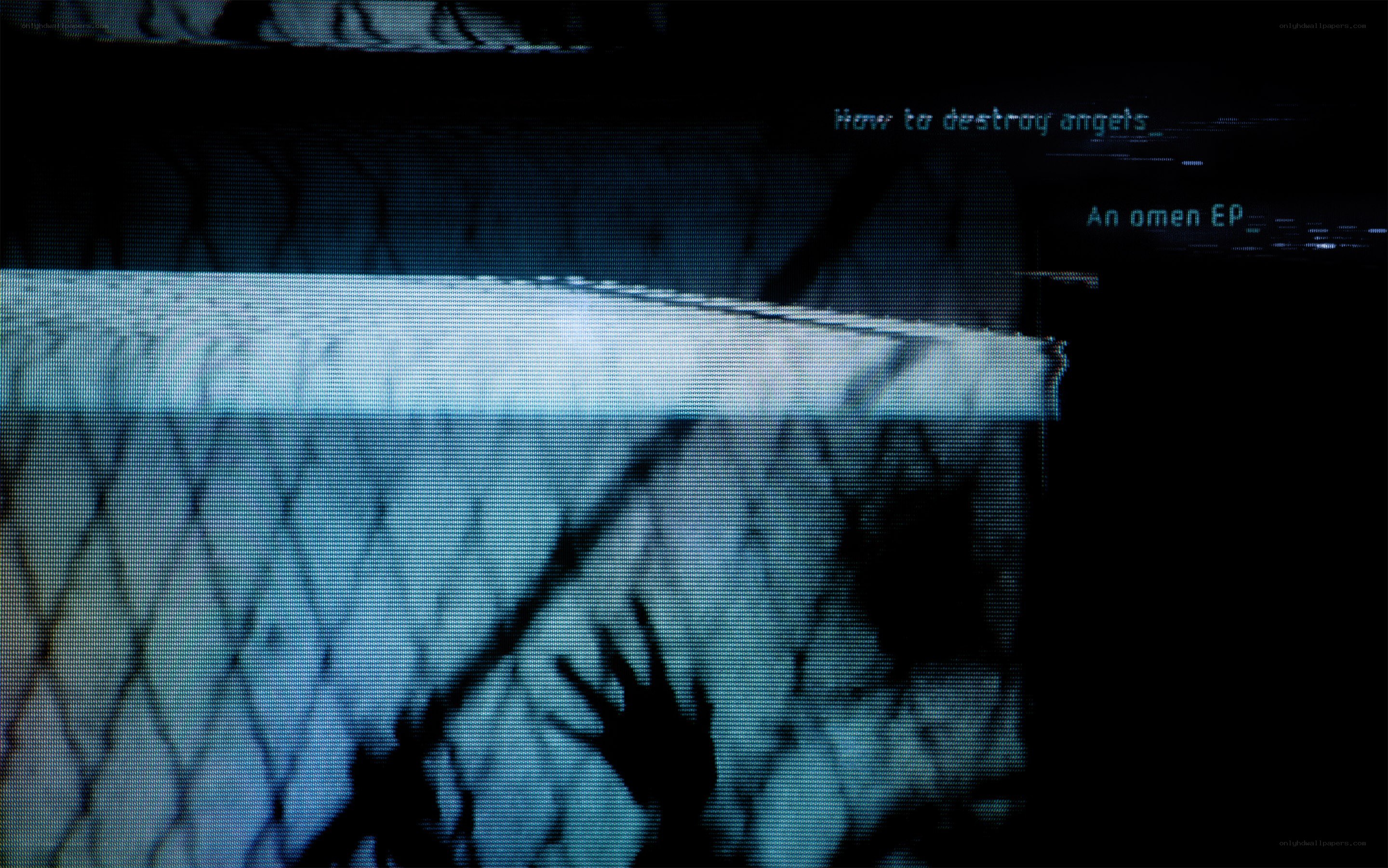 Hands behind a fence at night