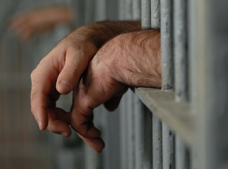 Hands Behind Bars