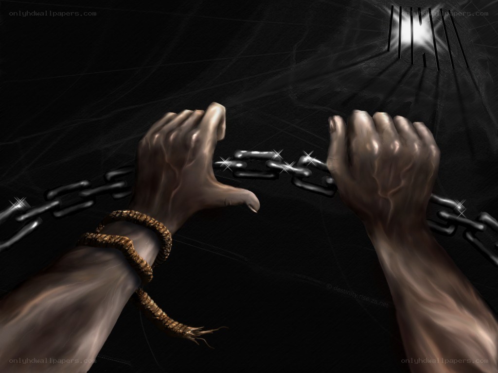 Hands breaking chains in prison