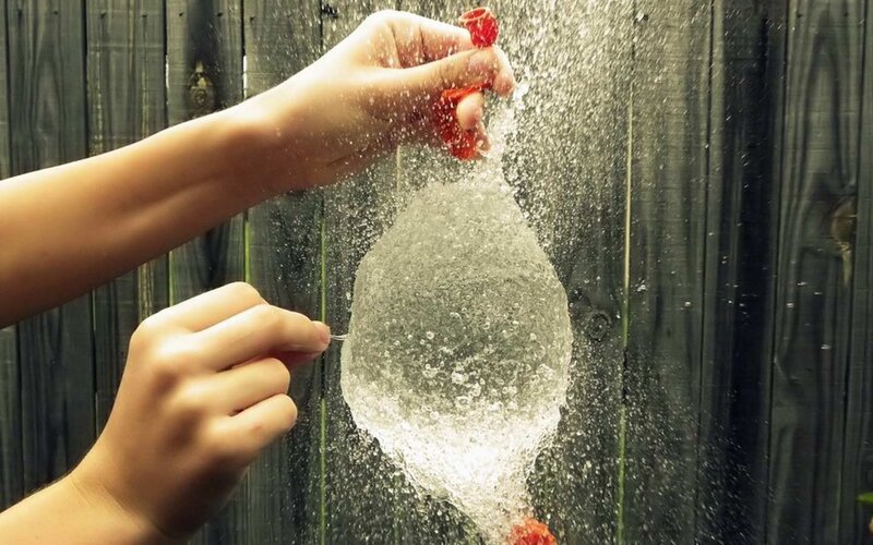 Hands Bursting Water Balloon
