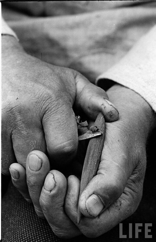 hands carving wood