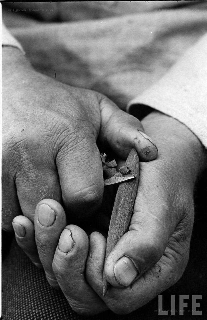 hands carving wood