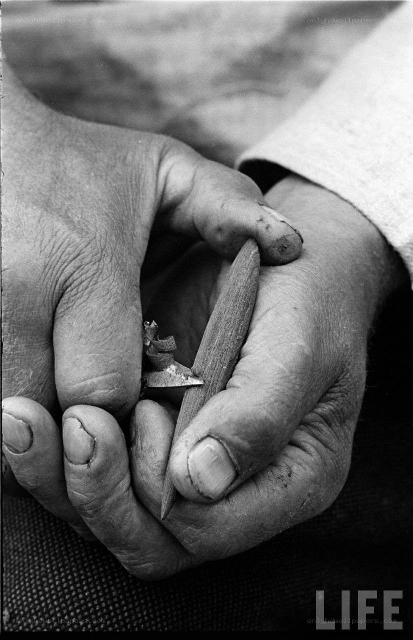 hands carving wood